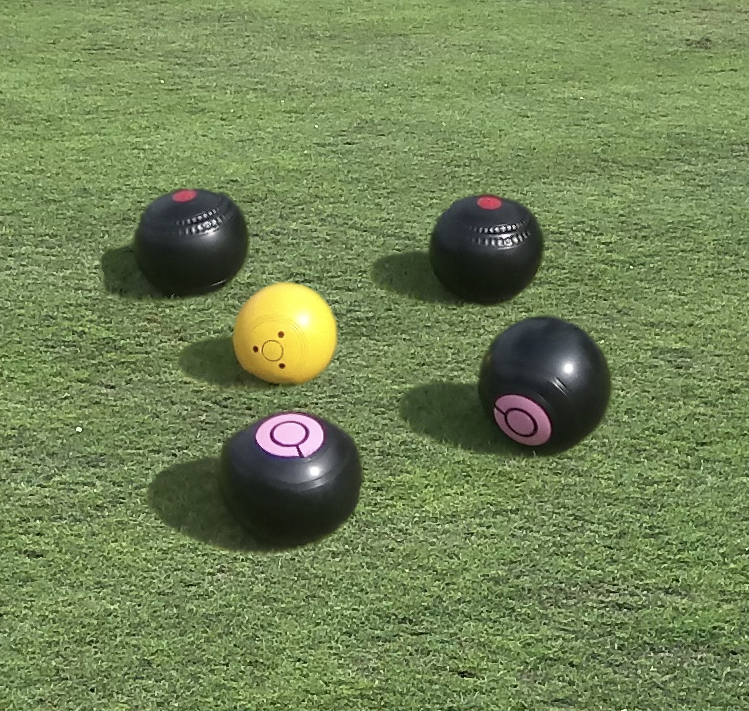 Four woods surrounding a yellow jack